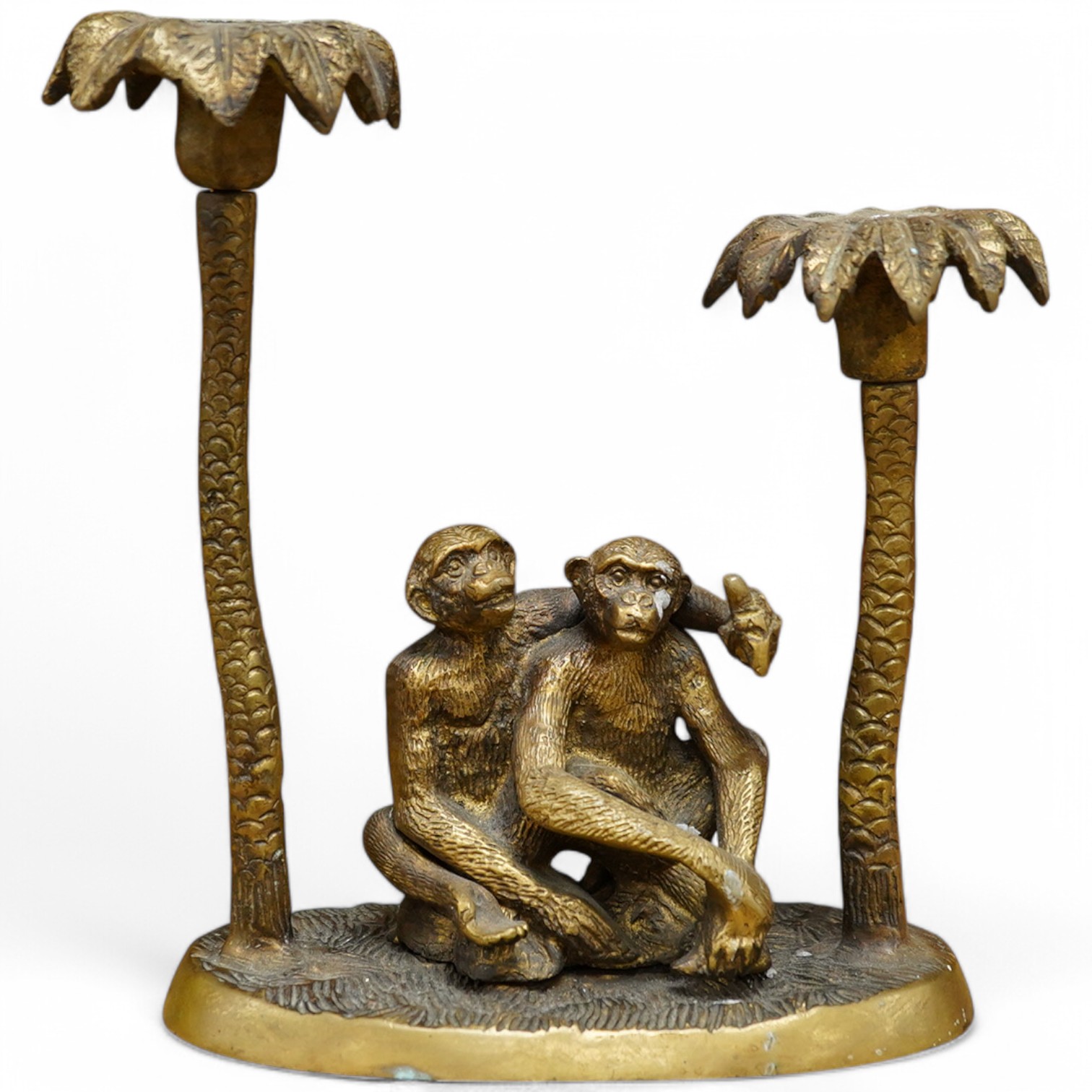 A brass two branch candleholder in the form of palm trees and monkeys, 22cm high. Condition - fair